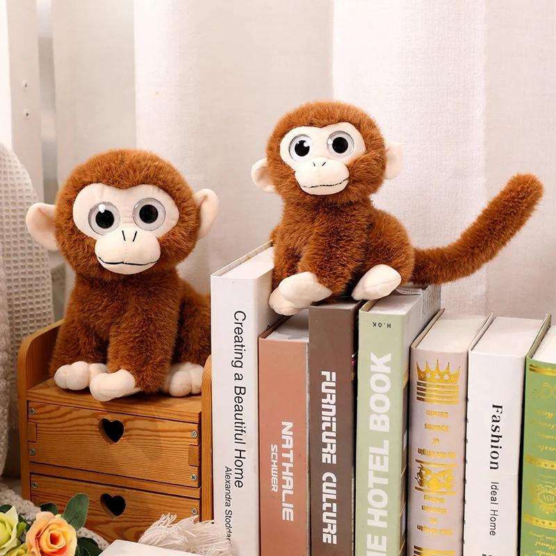 Plüschaffe mit großen Augen, weich und mit langem Schwanz, ideal als Dekoration oder Geburtstagsgeschenk für Kinder.