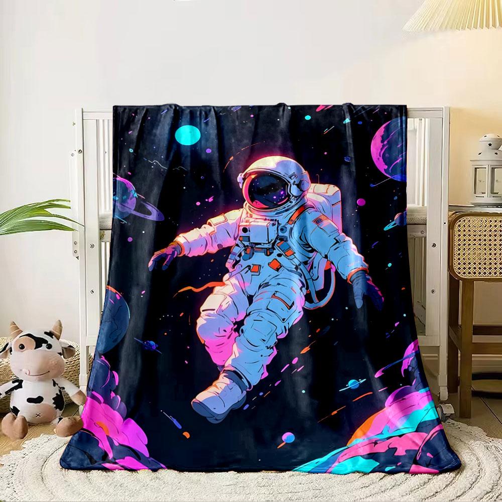 An astronaut floating in vibrant, colorful outer space with planets. for all seasons blanket lunch break throw gift 80cm x 120cm