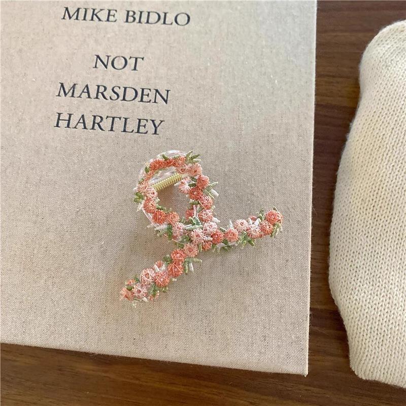 The Flower Hairpin Is Sweet and Ethereal. The Shark Hairpin Is Held At The Back of The Head
