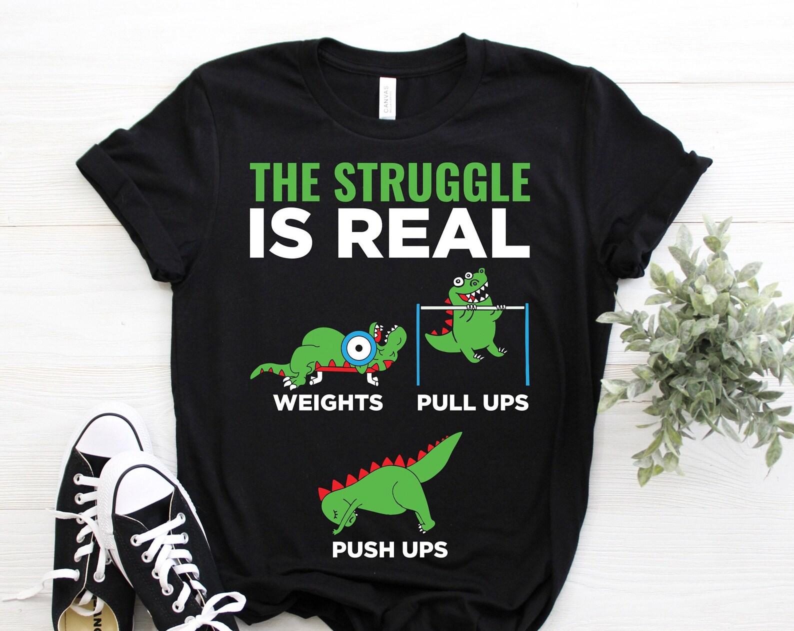 The Struggle Is Real Funny T-Rex Gym Workout Gift Funny T-Shirt, Dinosaurs Lover Tees, Bodybuilding Training Weight Lifting Fitness Athletes 100