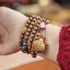 Nine-Tailed Fox Feng Jiu Bracelet with Sandalwood, Lacquer, Amber, and Southern Red Turquoise.