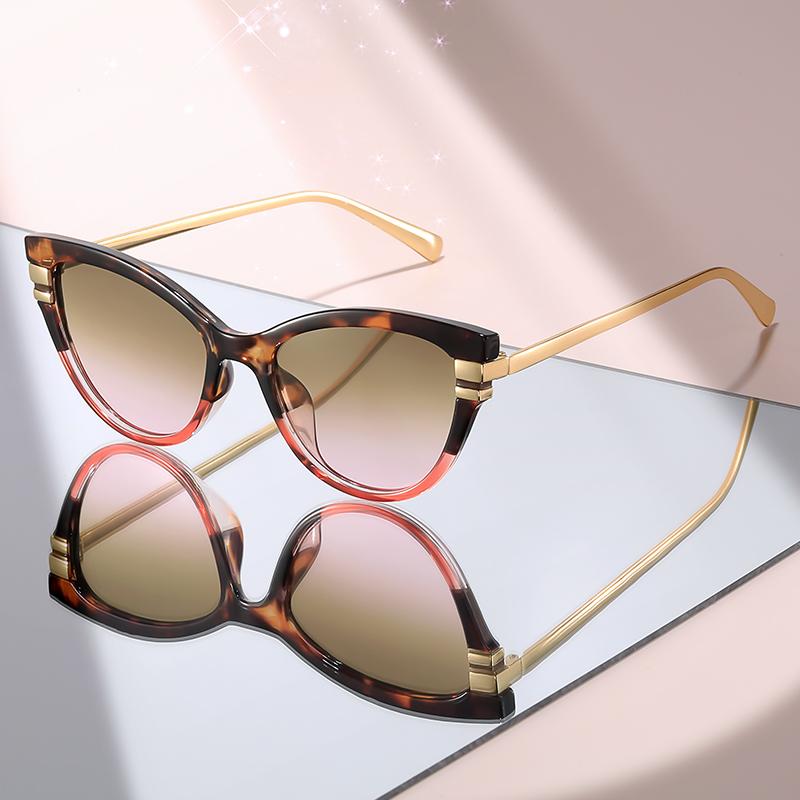 Fashion Cat Eye Sunglasses with Black Top Frame, Red Patterned Lower Frame, Gold Metal Arms, and Gradient Brown Lenses For