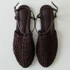 Sheepskin summer new niche woven Roman shoes one-word buckle flat bottom fishing net bag head sandals women wear half slippers