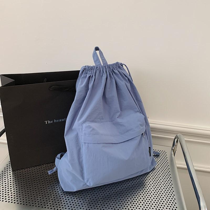 Japanese new simple light backpack commuter backpack drawstring pocket casual sports backpack men's and women's school bags