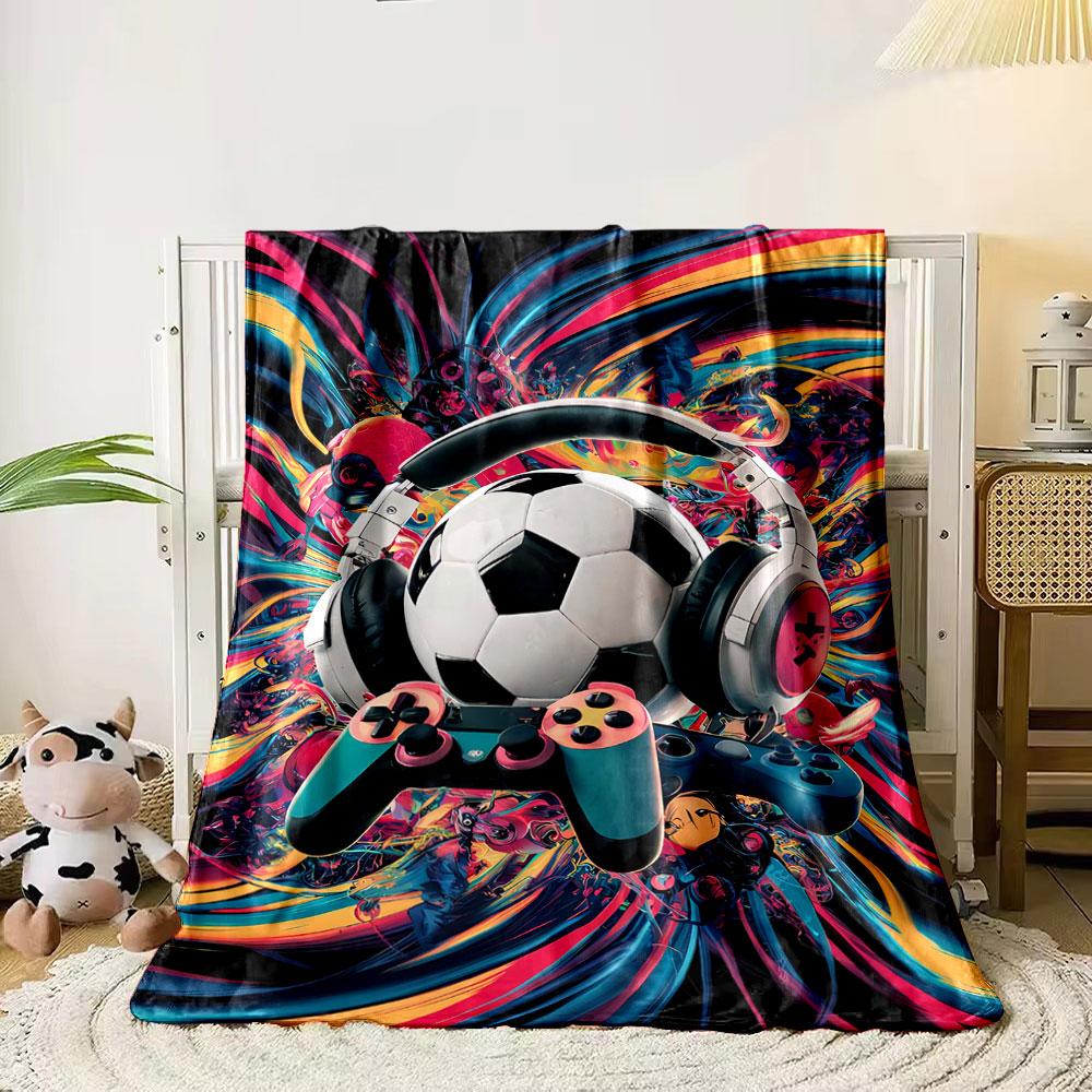 

A dynamic mix of a soccer ball, headphones, controllers, and vibrant swirls. for all seasons blanket lunch break throw gift 80cm x 120cm