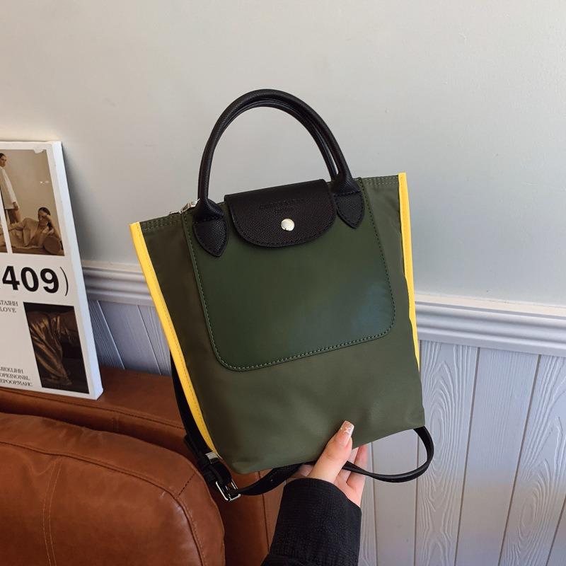 

Fashion niche contrasting color bag women s new versatile portable small bag summer messenger bucket bag зелений