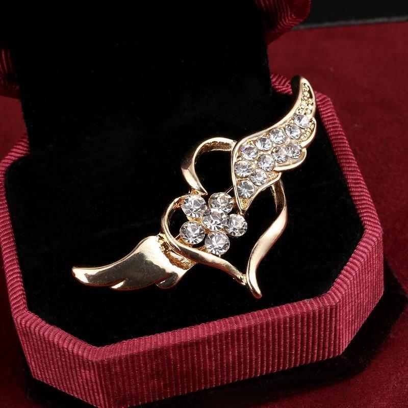 

Женская брошь с кристаллами в виде крыла ангела и цветка