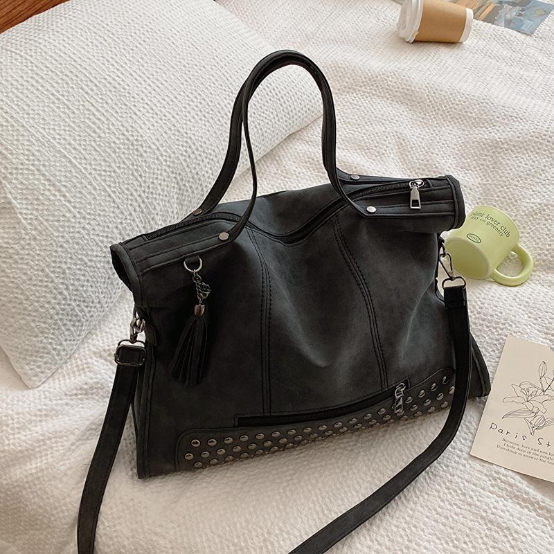 

New women s bag 2025 rivet fringed locomotive bag women s matte portable shoulder support extra large bag