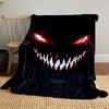 Sinister, glowing red eyes and sharp white teeth in a dark background. for all seasons blanket lunch break throw gift
