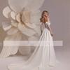 Robe de mariée à épaule dénudée à un mot dentelle française haut de gamme blanc satin fil de porte manches longues traîne bienvenue jupe de robe de soirée