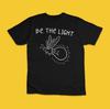 Be the Light Funny Firefly Light Bulb Motivational Graphic T-Shirt