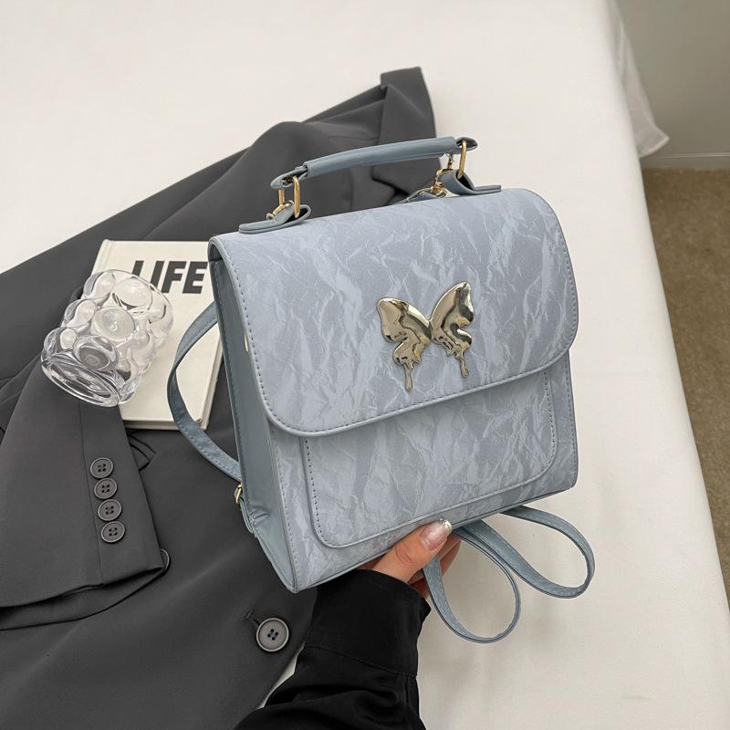 

Design sense of foreign style solid color 2024 new fashion leisure college style backpack simple fashion shoulder backpack women синій