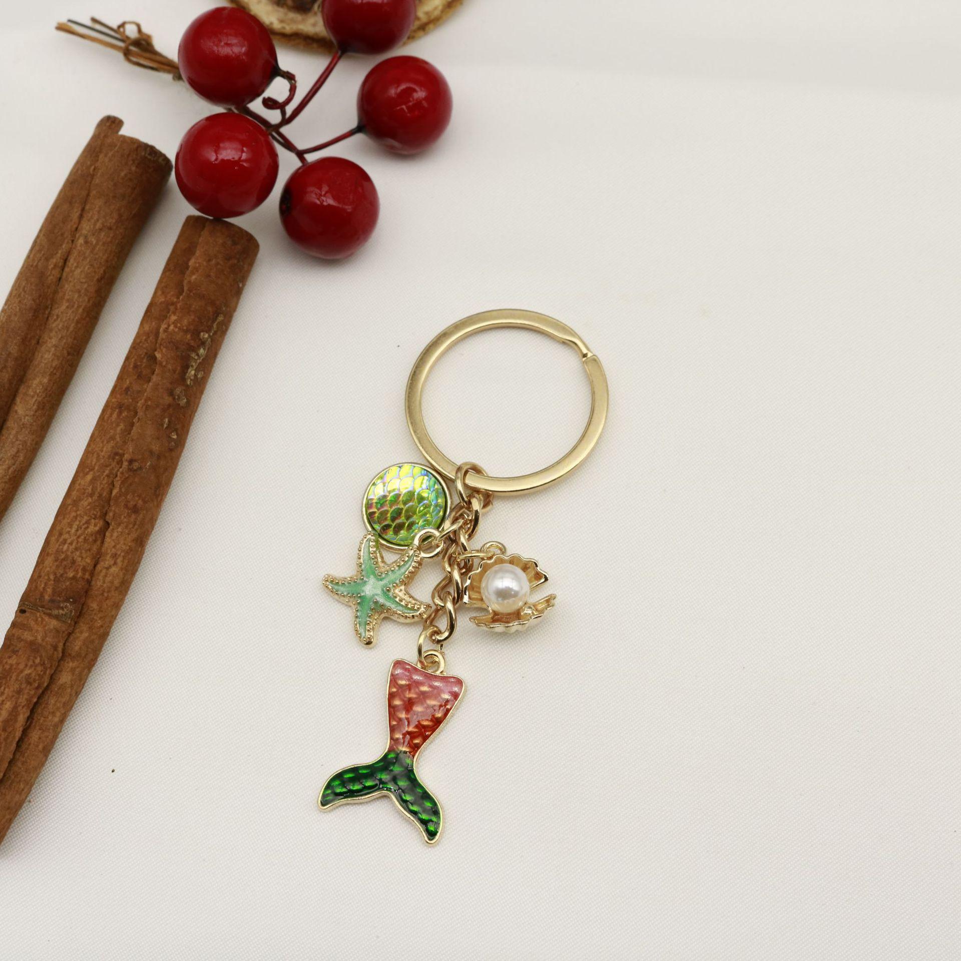Exquisite Ocean-Themed Keychain: Oil Drop Starfish, Dolphin, Shell, and Pearl Pendant золотой