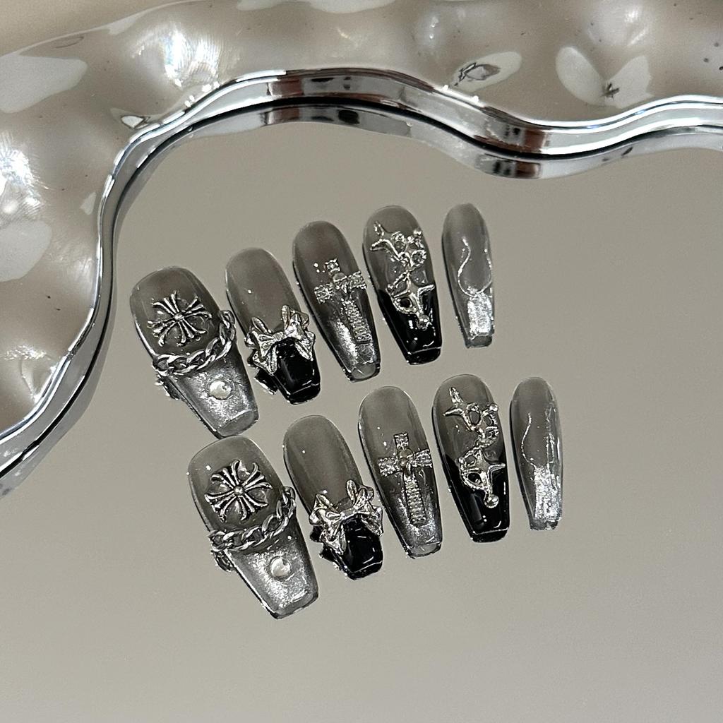 Skin-brightening grey press-on nails featuring detachable black Chrome Hearts-style crosses; entirely handmade.