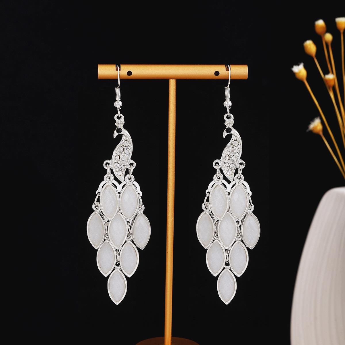 

Серьги-павлины в технике клуазоне: Дизайн тотемного колокольчика из серебра Феникса Мяо, популярный в живописных местах