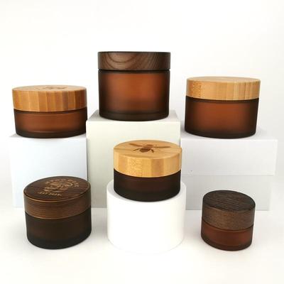 Bamboo Wood Packaging for Cosmetic Face Cream: Amber Frosted Glass Bottles In 50g, 100g, 150g, and 200g Sizes.