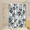 Light blue and black leaf patterned shower curtain, polyester fabric, with hooks, machine washable, suitable for bathroom decor.