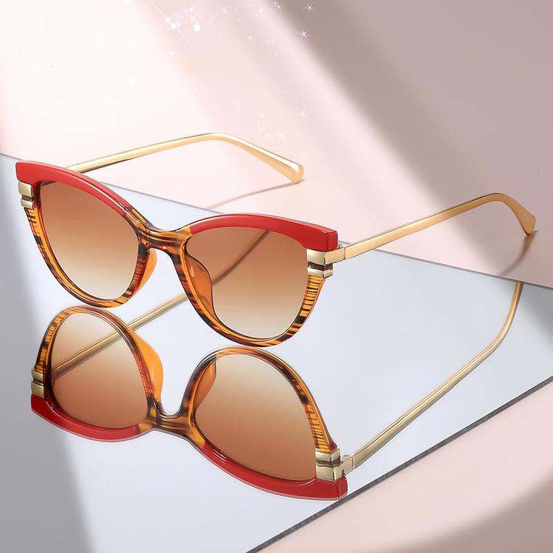 Fashion Cat Eye Sunglasses with Black Top Frame, Red Patterned Lower Frame, Gold Metal Arms, and Gradient Brown Lenses For