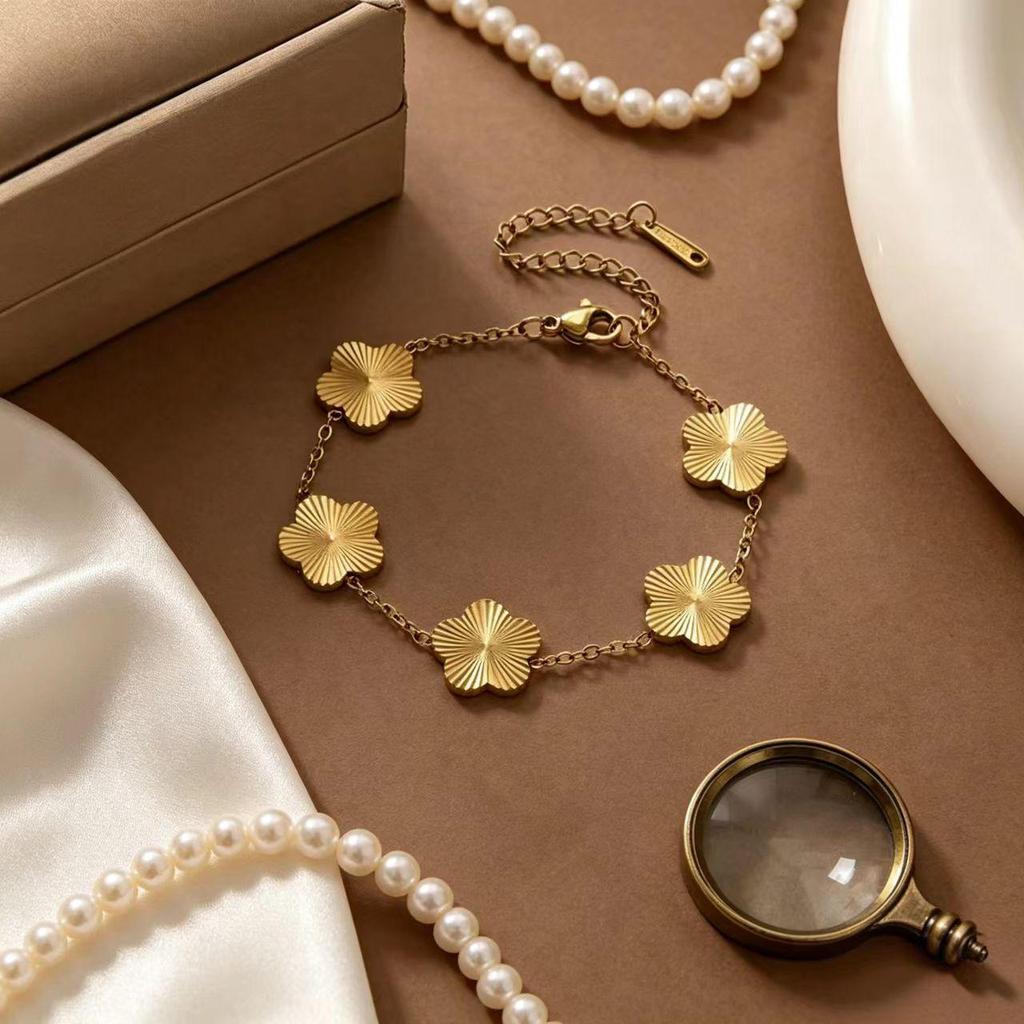 Gold-Plated Titanium Steel Four-Leaf Clover Jewelry Set: Necklace, Bracelet & Earrings for Women – Luxurious High-End Feel.