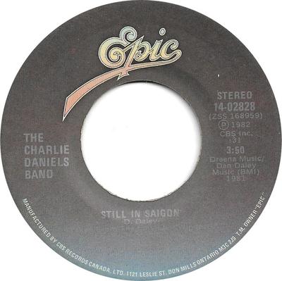 Disque 7 pouces CHARLIE DANIELS BAND - Still In Saigon / Blowing Along Wit 1402828 Epic 1982 Canada Rock Occasion