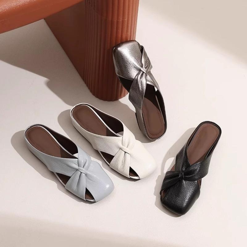 Hollow bag head slippers women's summer outer wear 2025 new versatile French flat bottom soft leather half drag high-end new models
