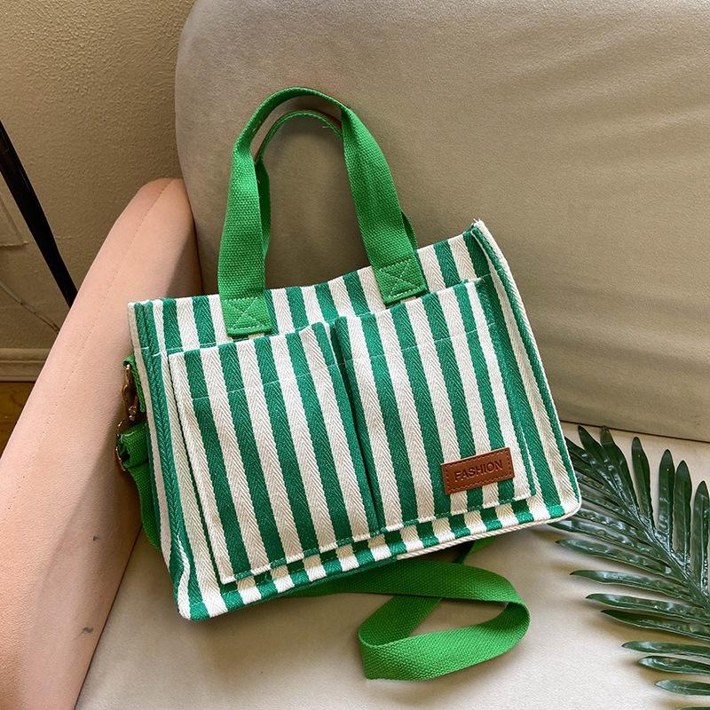 

Commuter large-capacity bag 2025 new women s bag popular striped canvas bag messenger bag fashionable portable tote bag зелений
