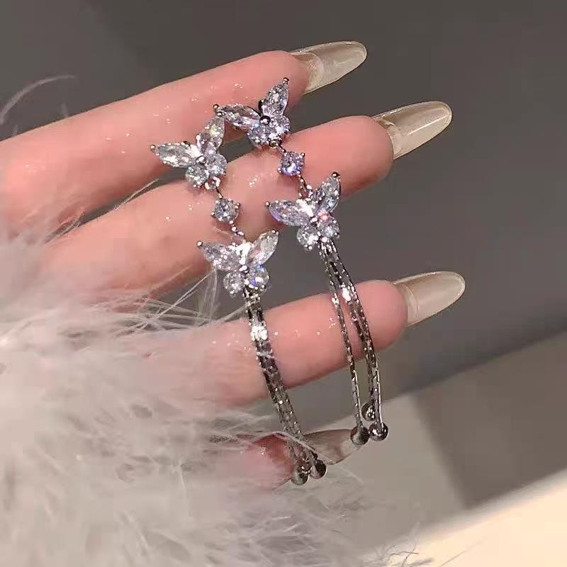 

Sweet and exquisite super flash butterfly fringed earrings female, new face thin long earrings Internet celebrity earrings серебряный
