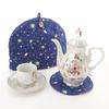 Stylish Scandinavian-style tea cozy with a blue, universe, planet, and garden design. Beige teapot cover. Crafted by artisans Sachiko and Akiko