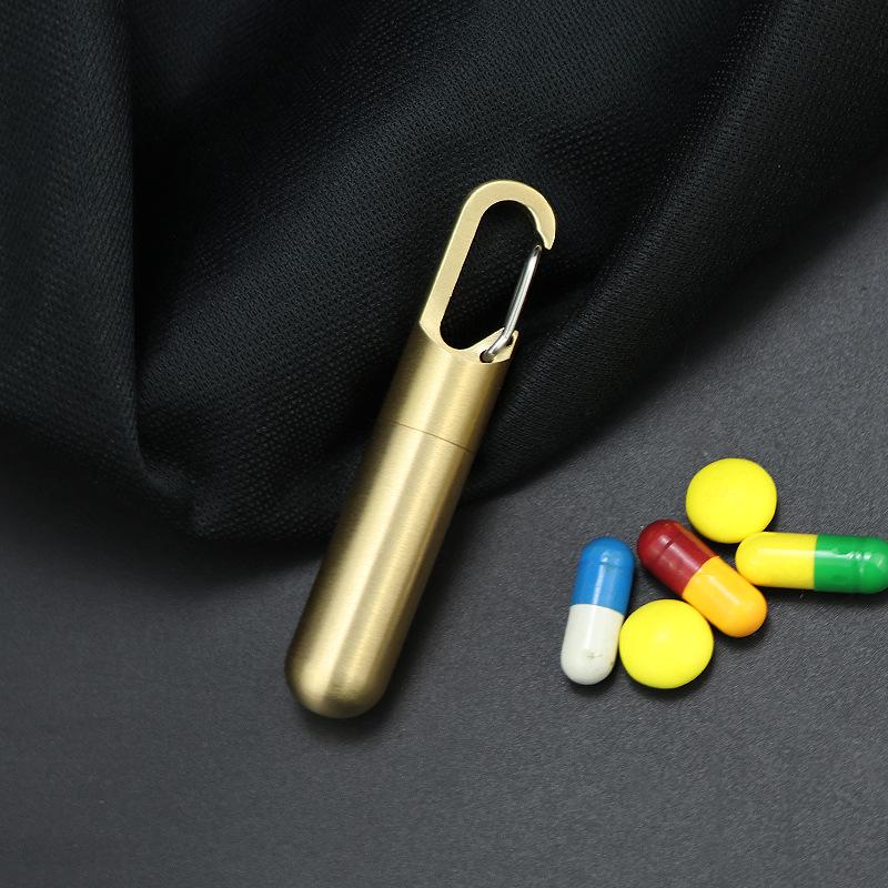 Compact Brass Pill Bottle: Waterproof, Dustproof, Moisture-Proof Storage Jar with Key Hook - Ideal for Travel or Everyday Use.
