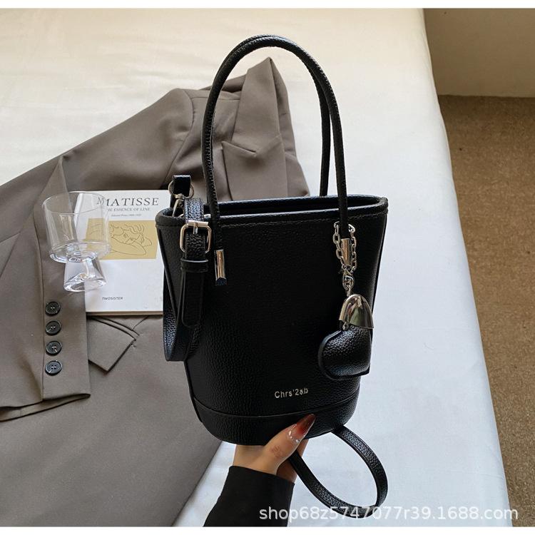 New niche simple solid color lychee pattern texture hand carrying bucket bag versatile foreign style commuting messenger women's bag