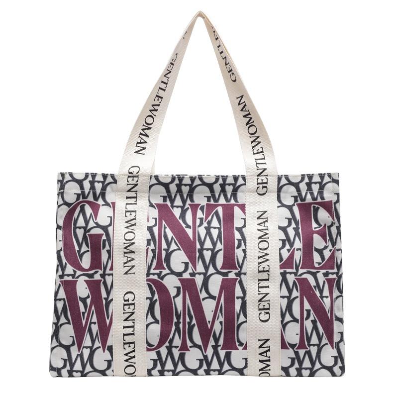 Large capacity alphabet canvas bag women's 2025 new fashion niche shoulder bag college student class commuter bag