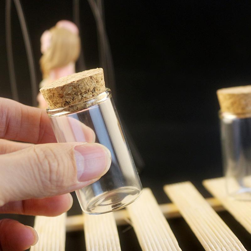 Botella de vidrio transparente de 15 ml con tapa y tapón de madera, cuentas de burbujas y capacidad de 20 ml.