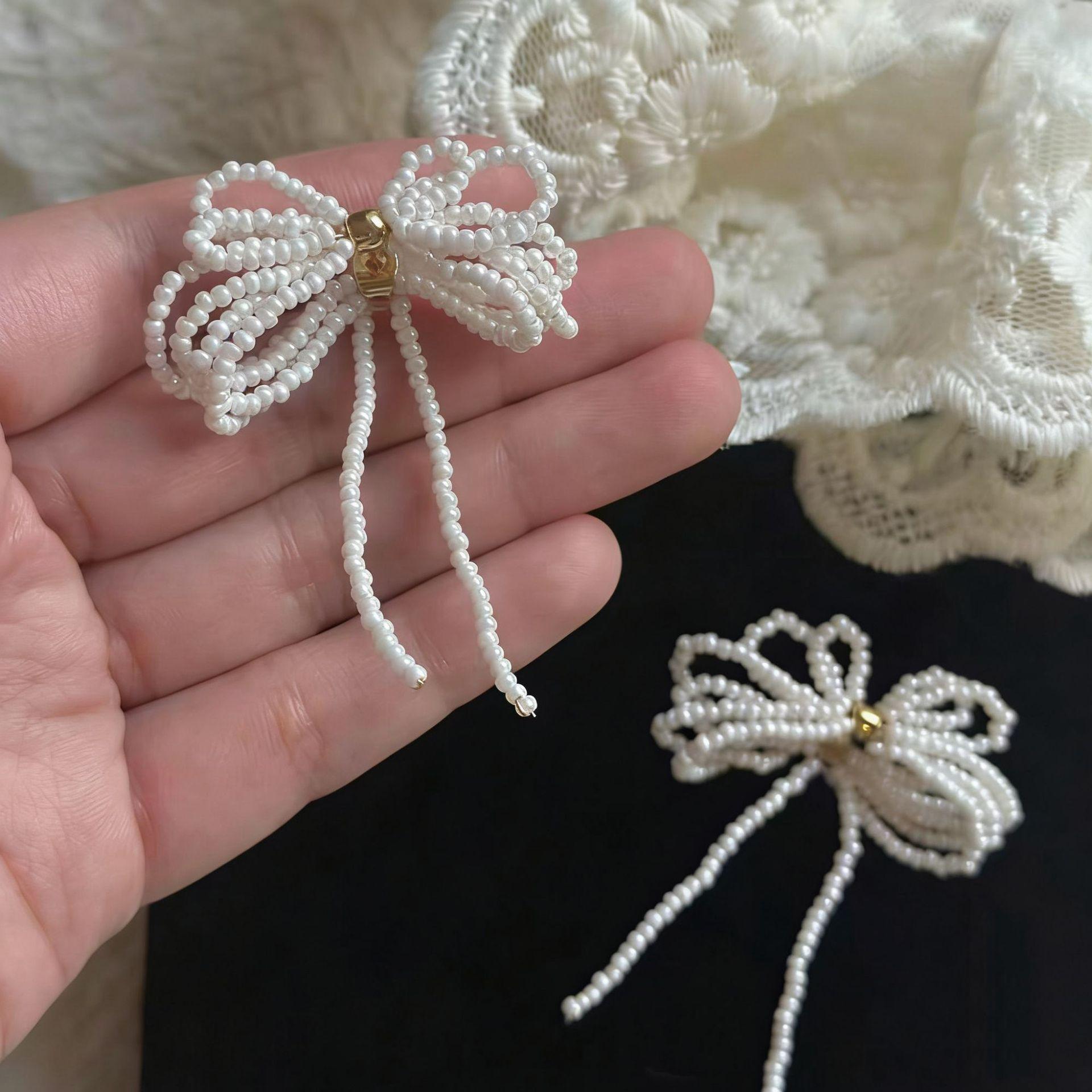 

Thousand gold wind bow pearl stud earrings sweet temperament fashion high value versatile niche design earrings earrings