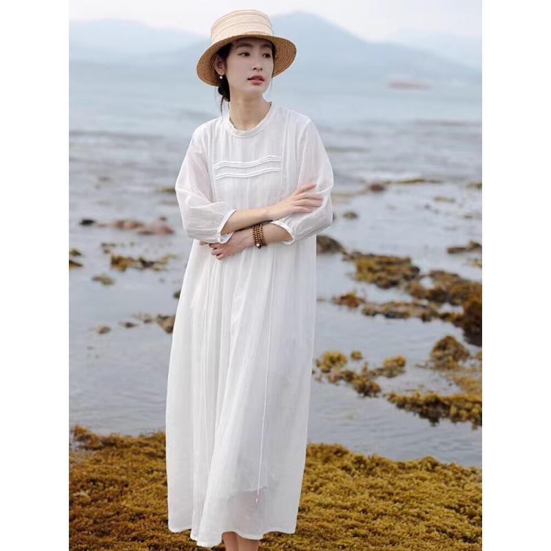 A Woman In A Double Layered Mid Length White Dress