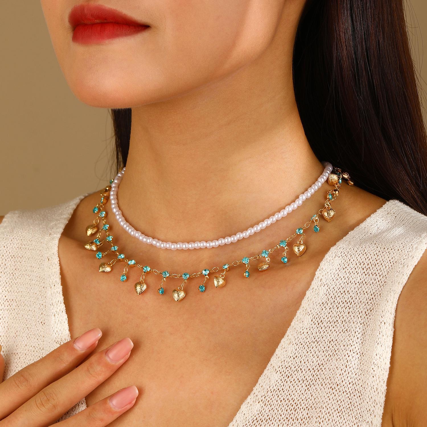 

Жіночий ювелірний набір високого класу в європейському та американському стилі: Двошаровий перловий чокер, намисто на ключицю, браслет та сережки