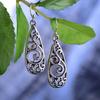 Retro Alloy Palace-Style Carved Floral Earrings for Women: Ethnic, Hollow Water Drop Design.