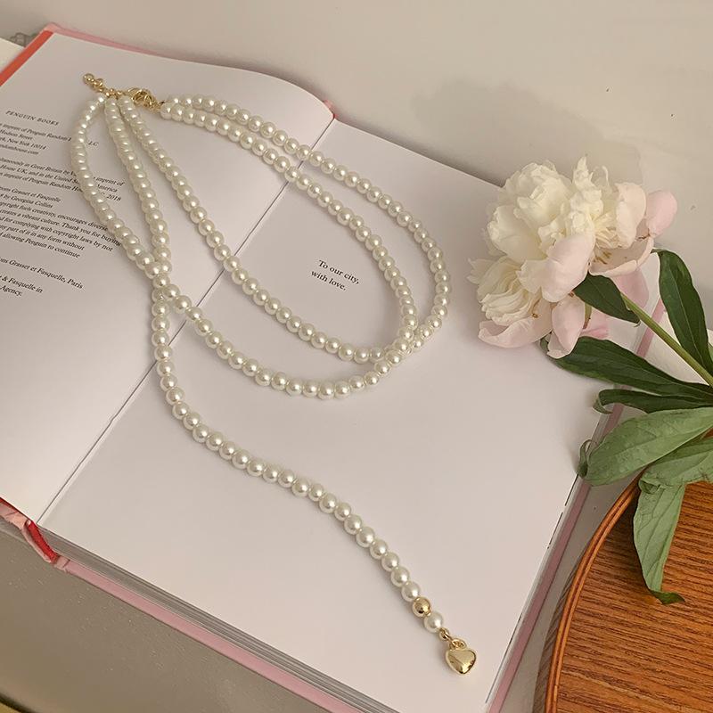 

Multi-layer stacked pearl necklace neck chain women s niche high-end temperament collarbone chain 2025 new explosion