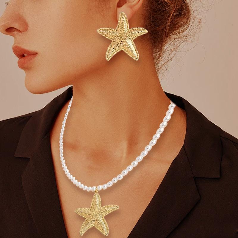 A new set of beach style imitation pearl starfish necklace and a pair of high-end starfish stud earrings.