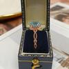 Anillo Yintai de Oro Rosa con Topacio Azul, Circonita Ovalada y Banda Trenzada - Exquisita Joyería de Lujo Ligero
