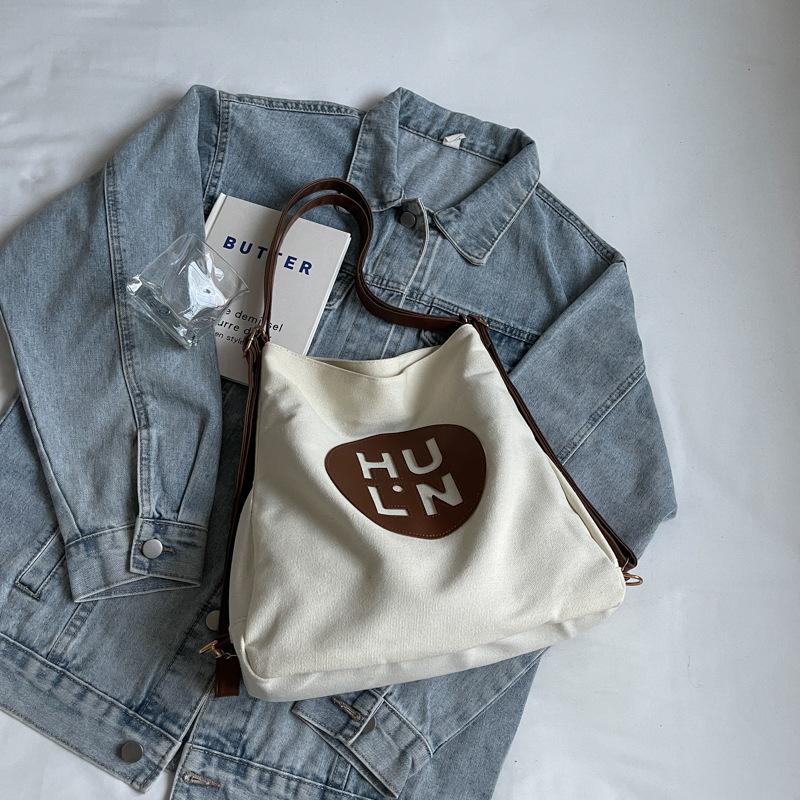 Plátěná taška dámská 2025 nová módní velkokapacitní víceúčelový batoh studentská třída ramenní nákupní taška