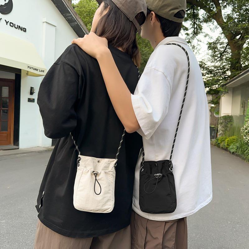 Stylish Crossbody Drawstring Bag: Trendy, Lightweight Cloth Phone Bag with Artistic Niche Design