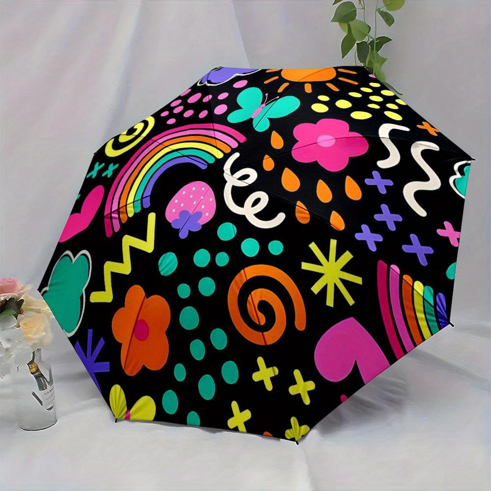 This Folding Umbrella Showcases Bright Designs Such As Rainbows, Butterflies, And Flowers Against a Black Backdrop. Ideal for