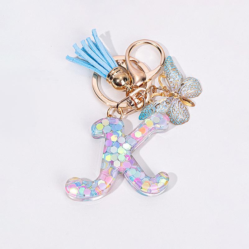 

Светло-голубой брелок-кисточка с пайетками-бабочками и эпоксидными 26 буквами