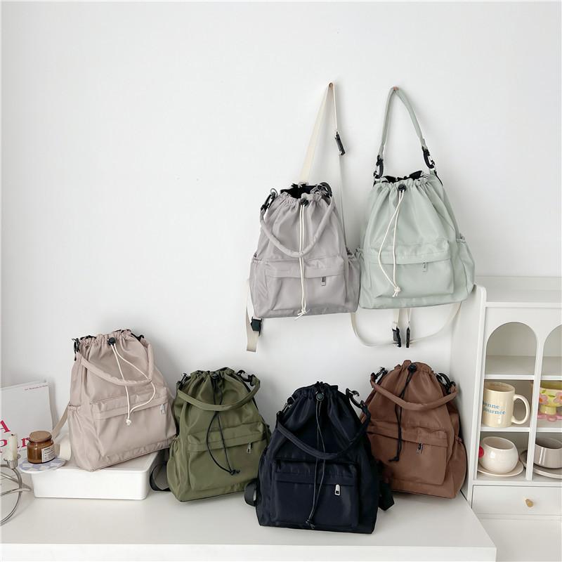 Daily versatile student schoolbag new niche design drawstring bundle shoulder bag simple commuter backpack women