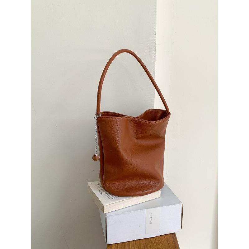 

Summer new hand carry soft leather bucket bag niche versatile commuter underarm bag large capacity cylinder shoulder bag women коричневый