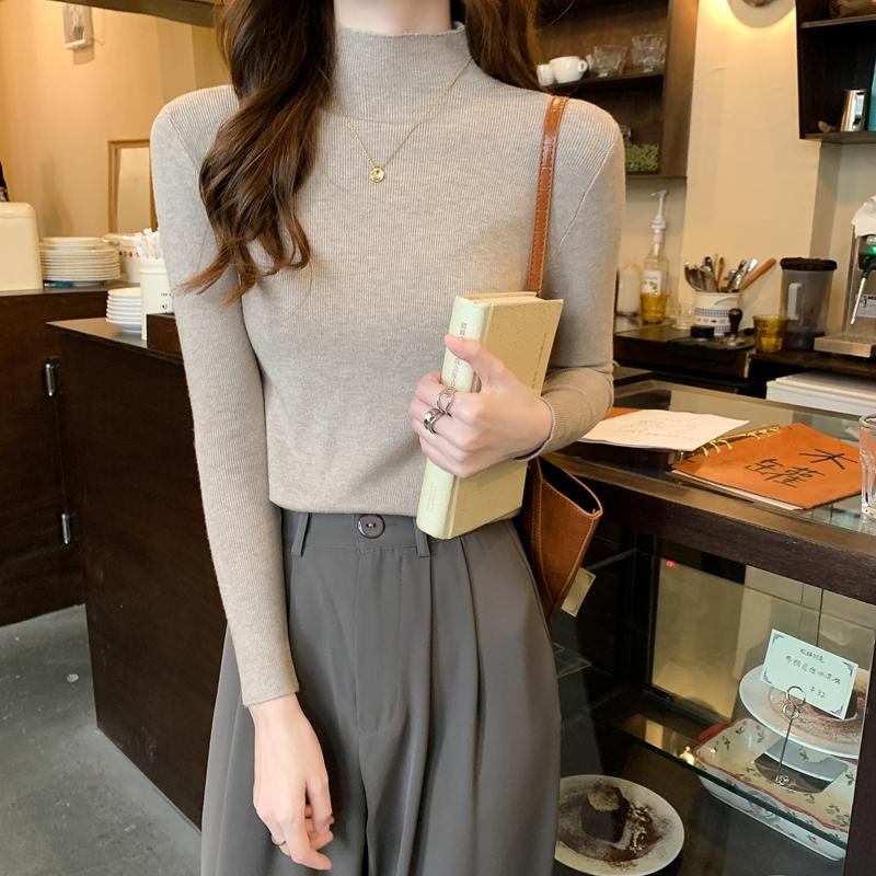 Nuevo invierno ajustado tejido de punto Color sólido cuello redondo señoras moda camisa por el trasero suéter mujer ropa