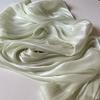 Soft shiny creased organza fabric with a smooth texture suitable for wedding dresses formal gowns and designer clothing fabrics