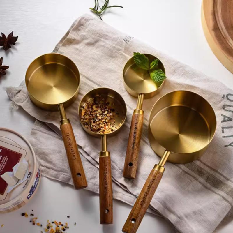 A Set of Eight Stainless Steel Measuring Cups and Wooden Handled Spoons for Kitchen Baking Tools, Measuring Tools, and Scales