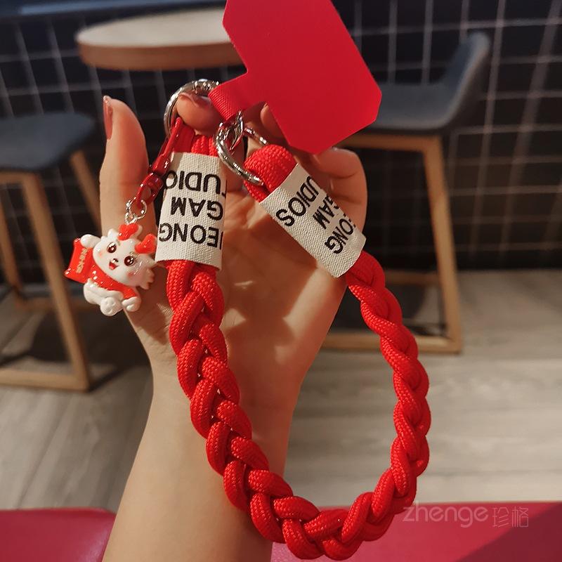 

Red three-stranded ponytail hand rope ins women s mobile phone lanyard portable wrist short lucky dragon year pendant