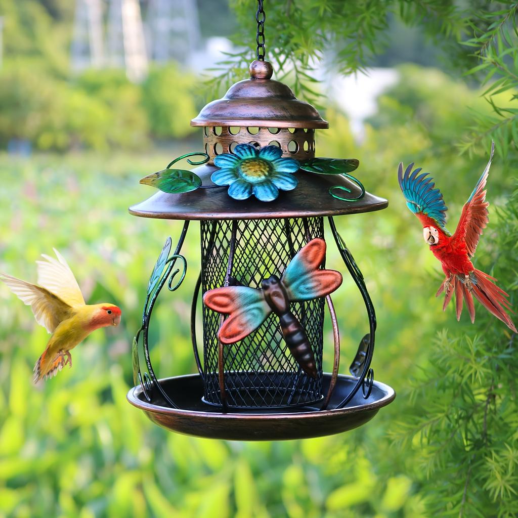 An outdoor hanging bird feeder with hooks and iron mesh, featuring decorative dragonfly and flower patterns, suitable for use in gardens or